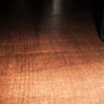 Wooden table with green bottle