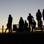 People's silhouette against sunset